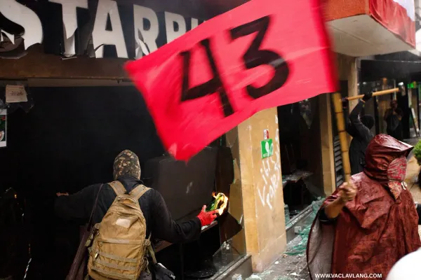 One of the protesters throws a Molotov cocktail into a Starbucks café.